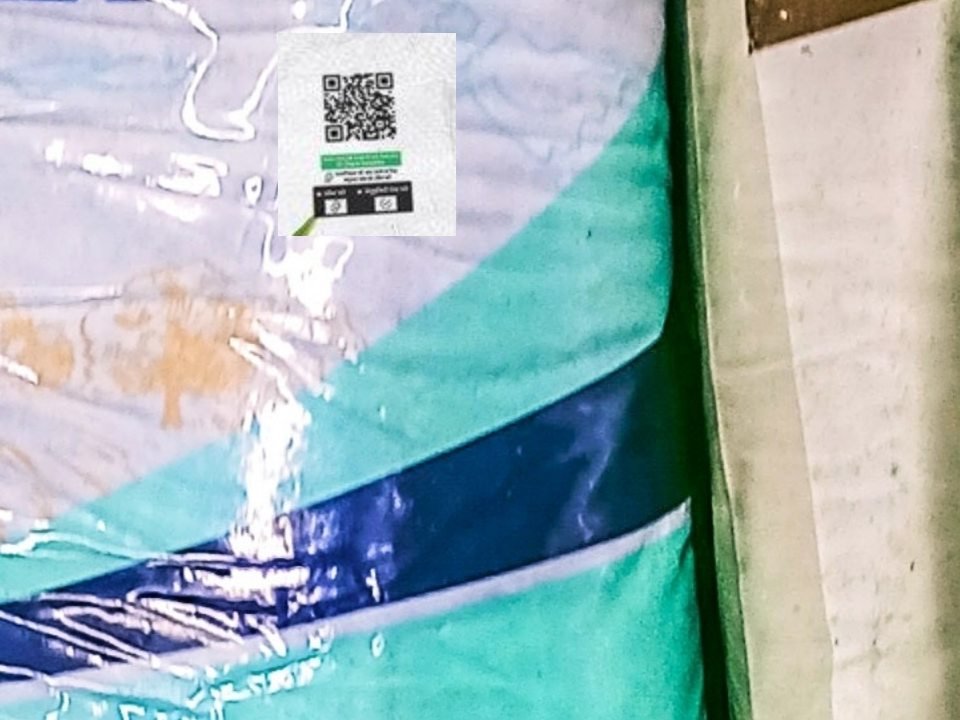A serialised QR code label printed on a filled fertiliser bag